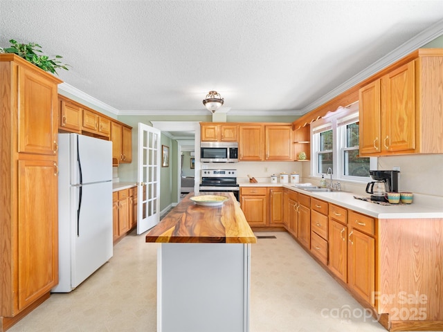173 Odoms Chapel Rd, Bakersville, NC 28705 - kitchen with stainless steel appliances, light floors, a sink, butcher block counters, and a textured ceiling