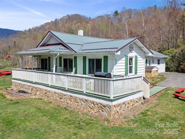 173 Odoms Chapel Rd, Bakersville, NC 28705 - back of property featuring a porch, a chimney, a yard, and metal roof
