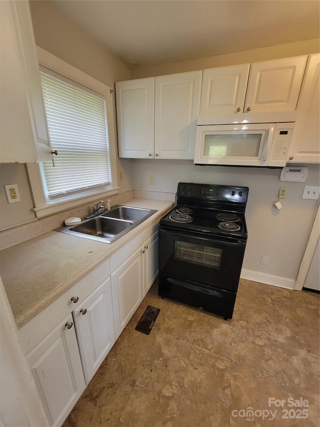 kitchen featuring white cabinets, visible vents, black range with electric stovetop, a sink, and white microwave