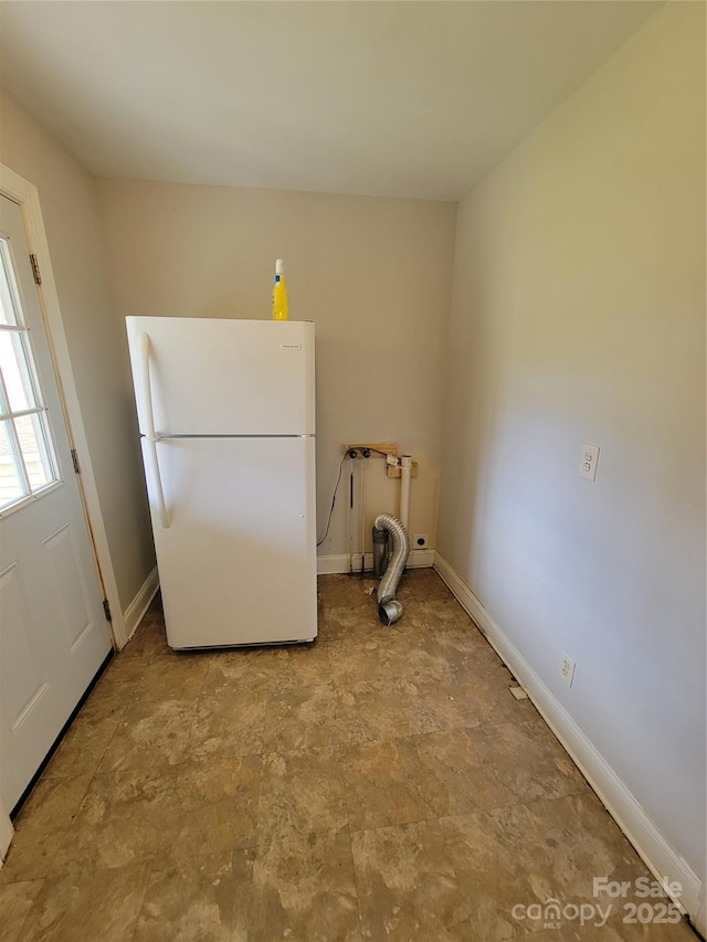 washroom featuring stone finish flooring and baseboards