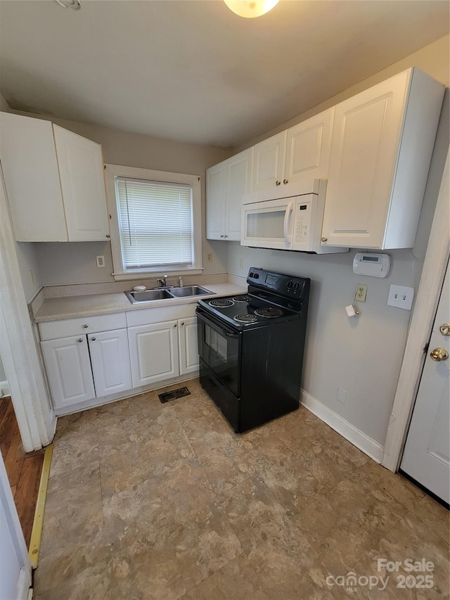 kitchen featuring white cabinets, white microwave, black electric range oven, and a sink
