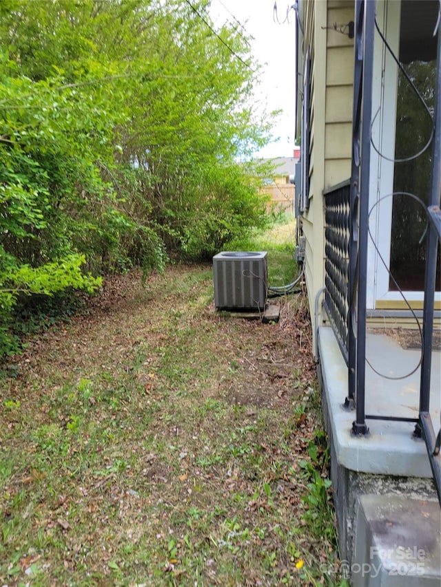 view of yard with central AC