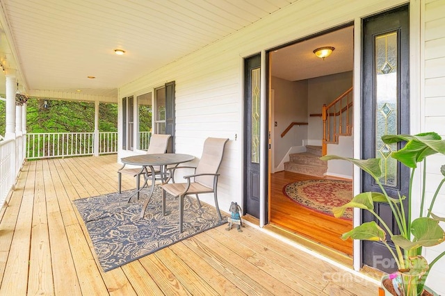 wooden terrace featuring covered porch