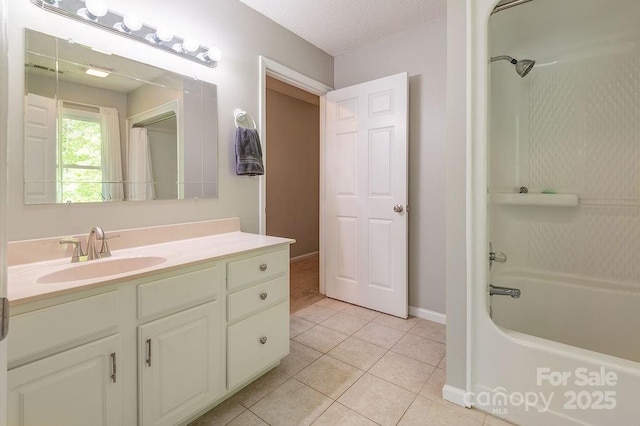 bathroom featuring baseboards, tile patterned flooring, bathing tub / shower combination, and vanity