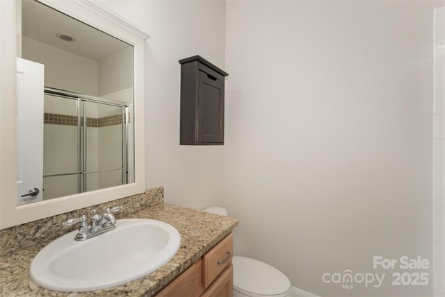 562 New Bern Station Ct, Charlotte, NC 28209 - full bathroom featuring a stall shower, vanity, and toilet