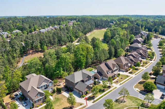 aerial view featuring a wooded view and a residential view
