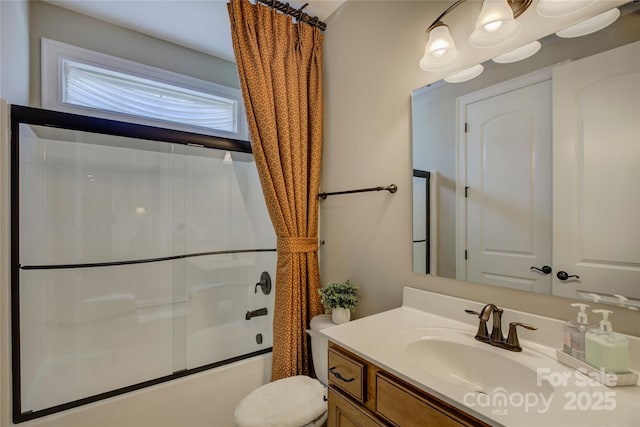 full bath featuring vanity, enclosed tub / shower combo, and toilet