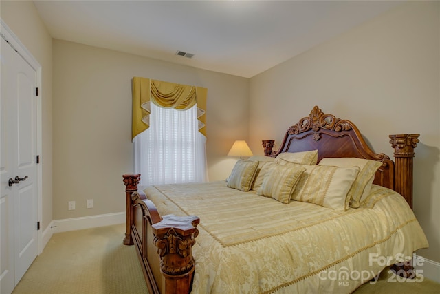 bedroom with baseboards and carpet