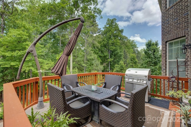 wooden deck featuring outdoor dining area and area for grilling