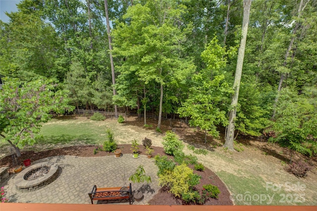 view of yard with a patio, a fire pit, and fence