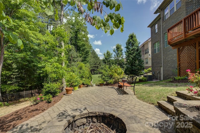view of patio / terrace with fence and an outdoor fire pit
