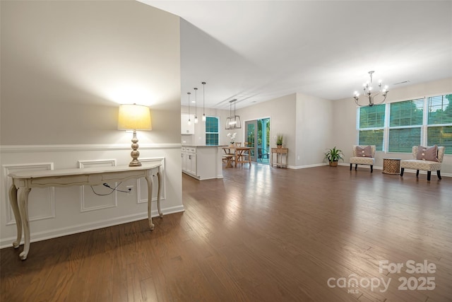 interior space with baseboards, dark wood finished floors, and a chandelier