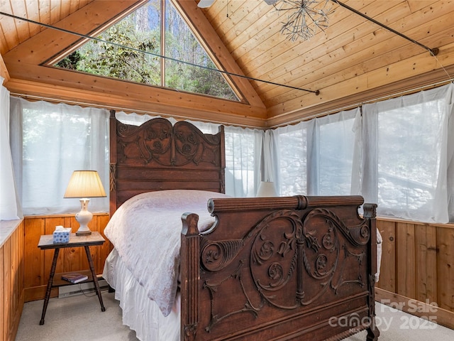bedroom featuring vaulted ceiling, carpet flooring, wood walls, and wood ceiling
