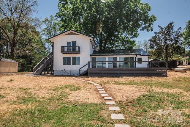 451 S Strand Dr, Norwood, NC 28128 - back of property with an outdoor structure, a storage unit, a lawn, and stairway