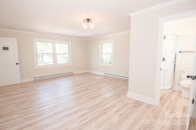 451 S Strand Dr, Norwood, NC 28128 - interior space with a baseboard heating unit, baseboards, ornamental molding, and light wood-type flooring
