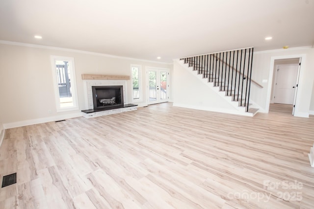 451 S Strand Dr, Norwood, NC 28128 - unfurnished living room with light wood-style flooring, visible vents, stairs, and ornamental molding