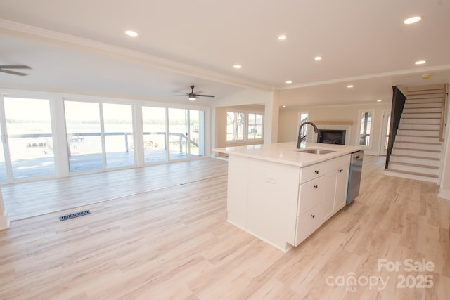 451 S Strand Dr, Norwood, NC 28128 - kitchen featuring ceiling fan, open floor plan, a sink, and visible vents