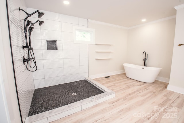 451 S Strand Dr, Norwood, NC 28128 - bathroom with a freestanding bath, a tile shower, recessed lighting, wood finished floors, and ornamental molding