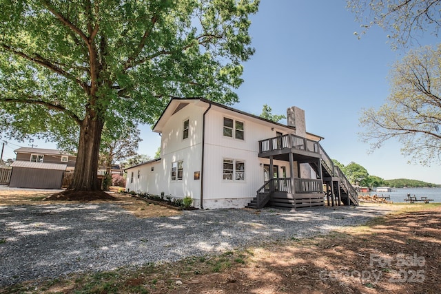 451 S Strand Dr, Norwood, NC 28128 - back of property with a chimney, a storage shed, a balcony, a wooden deck, and an outbuilding