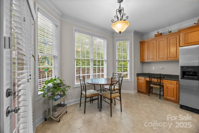 dining room with crown molding, baseboards, and light tile patterned floors