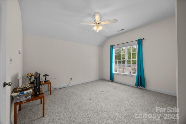 unfurnished room with ceiling fan, carpet, baseboards, vaulted ceiling, and visible vents