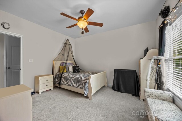 carpeted bedroom featuring ceiling fan