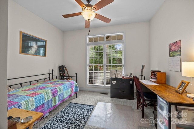 carpeted bedroom featuring ceiling fan and visible vents