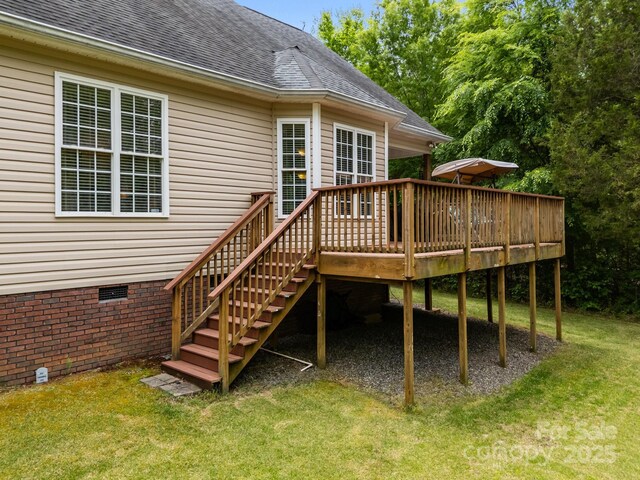 wooden deck with a lawn and stairway
