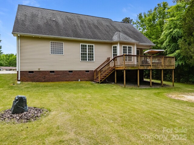 rear view of house featuring a wooden deck, stairs, a shingled roof, crawl space, and a yard