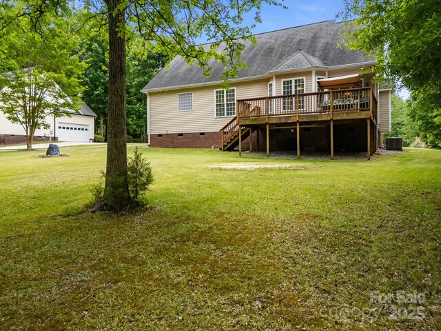 back of house featuring a garage, a deck, stairway, crawl space, and a lawn
