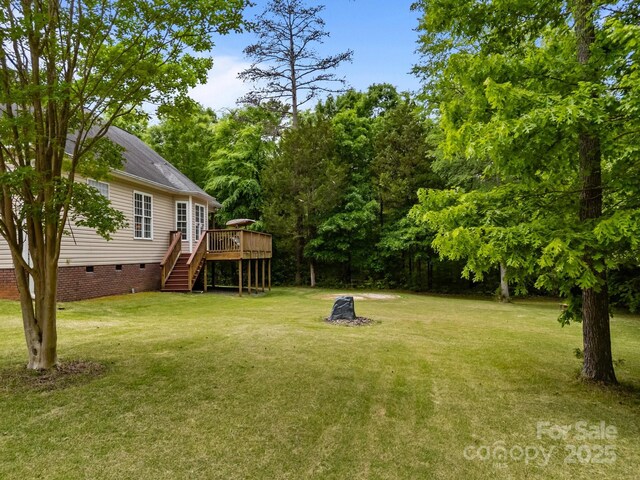 view of yard with stairs and a deck