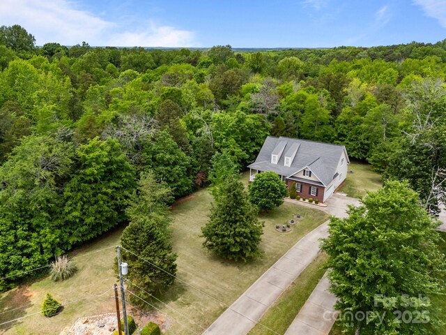aerial view featuring a wooded view