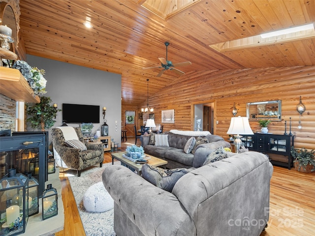 living room featuring wooden ceiling, wood finished floors, lofted ceiling with skylight, and a wood stove