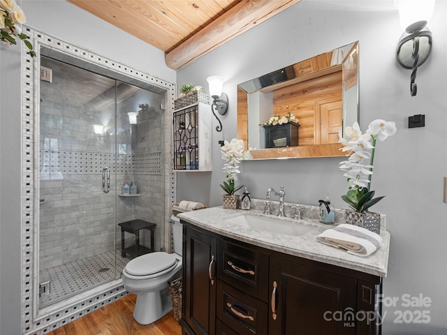 full bathroom featuring wood finished floors, a stall shower, vanity, wood ceiling, and toilet