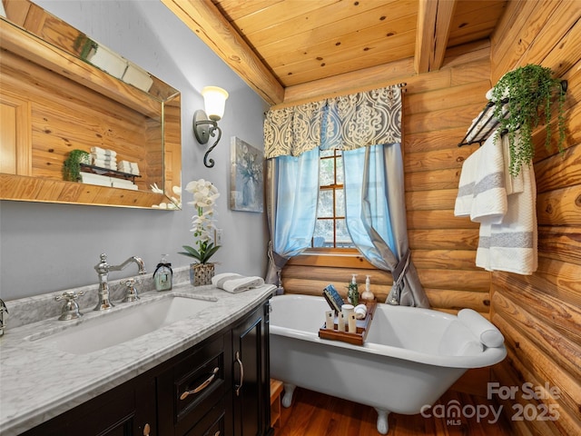 bathroom featuring wood finished floors, rustic walls, vanity, wood ceiling, and a soaking tub