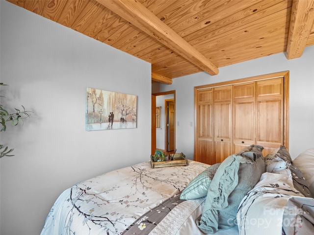 bedroom featuring wood ceiling, beamed ceiling, and a closet