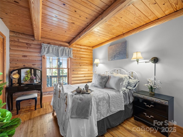 bedroom featuring beamed ceiling, wood finished floors, log walls, and wooden ceiling