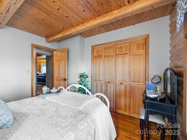 bedroom featuring wood ceiling, wood finished floors, beamed ceiling, and a closet