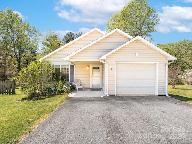 ranch-style house with fence, a front lawn, driveway, and a garage