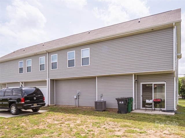14727 Choate Cir Unit 2, Charlotte, NC 28273 - rear view of house featuring a lawn, central air condition unit, and a garage