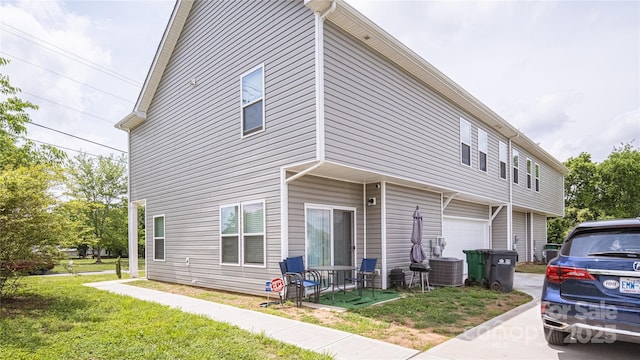 14727 Choate Cir Unit 2, Charlotte, NC 28273 - view of home's exterior featuring central air condition unit, an attached garage, and a lawn