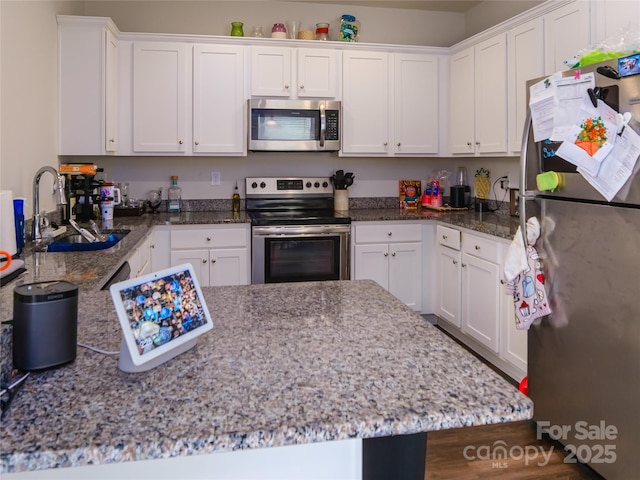 14727 Choate Cir Unit 2, Charlotte, NC 28273 - kitchen featuring a sink, stainless steel appliances, light stone counters, and white cabinets