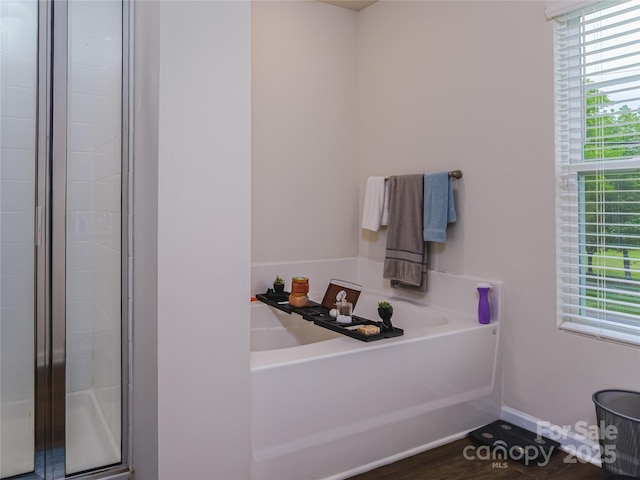 14727 Choate Cir Unit 2, Charlotte, NC 28273 - bathroom with a shower stall, baseboards, a bath, and wood finished floors