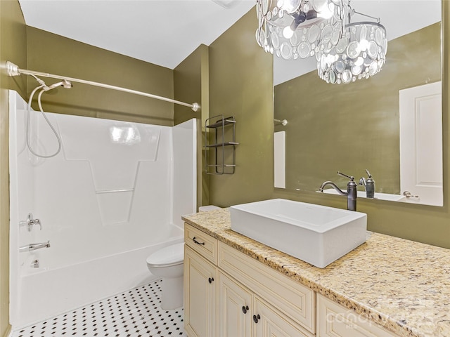 full bath with toilet, vanity, shower / tub combination, and an inviting chandelier