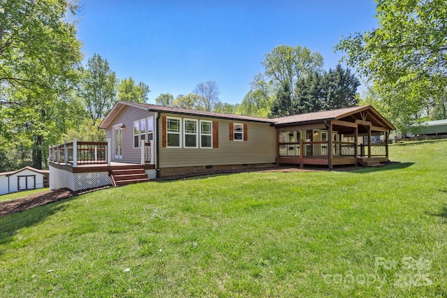 2942 Denwood Dr, Claremont, NC 28610 - back of property featuring a yard, crawl space, a wooden deck, an outdoor structure, and a storage unit