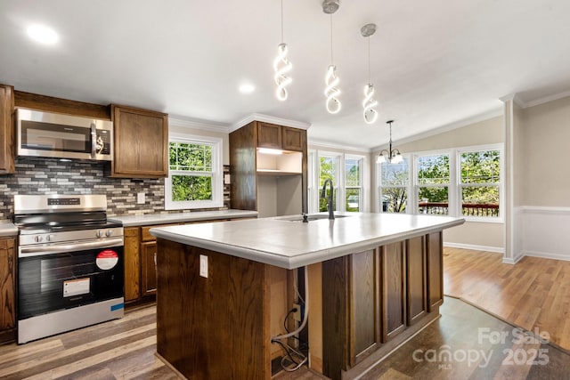 2942 Denwood Dr, Claremont, NC 28610 - kitchen with a sink, light wood-type flooring, decorative backsplash, light countertops, and appliances with stainless steel finishes