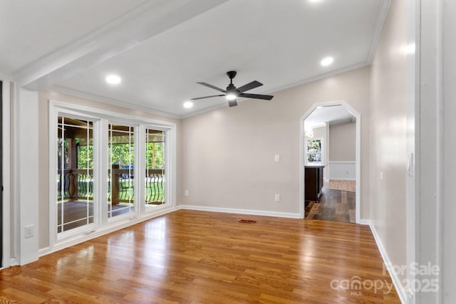 2942 Denwood Dr, Claremont, NC 28610 - empty room featuring arched walkways, plenty of natural light, and crown molding