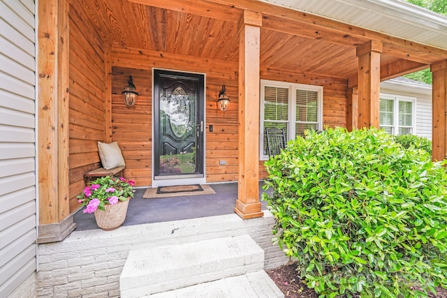 view of exterior entry with a porch