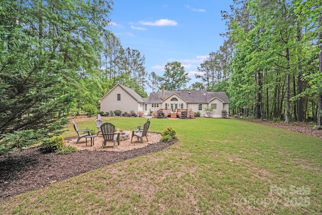 view of yard with a fire pit