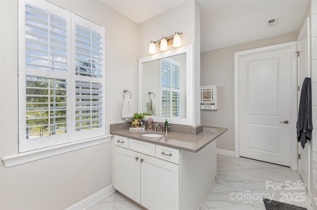 bathroom featuring marble finish floor, baseboards, vanity, and visible vents